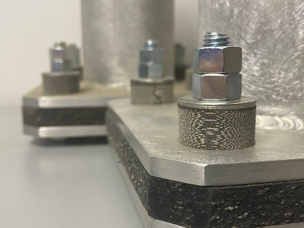 two steel bolt connections with fabreeka pad and sa47 pad to show how to prevent galvanic corrosion