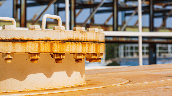 White steel cover that is badly corroded from rust